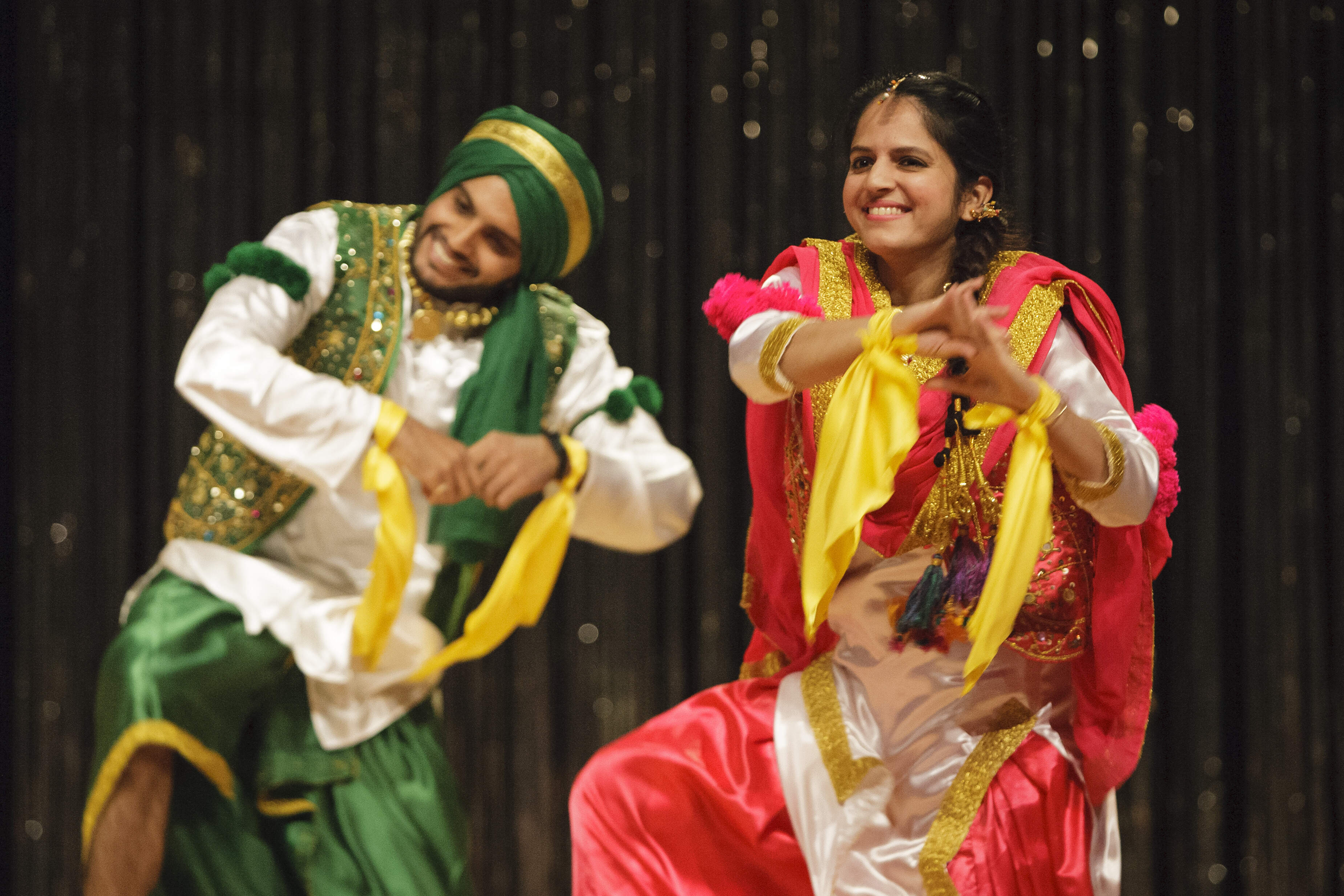 Two people at a cultural performance dancing