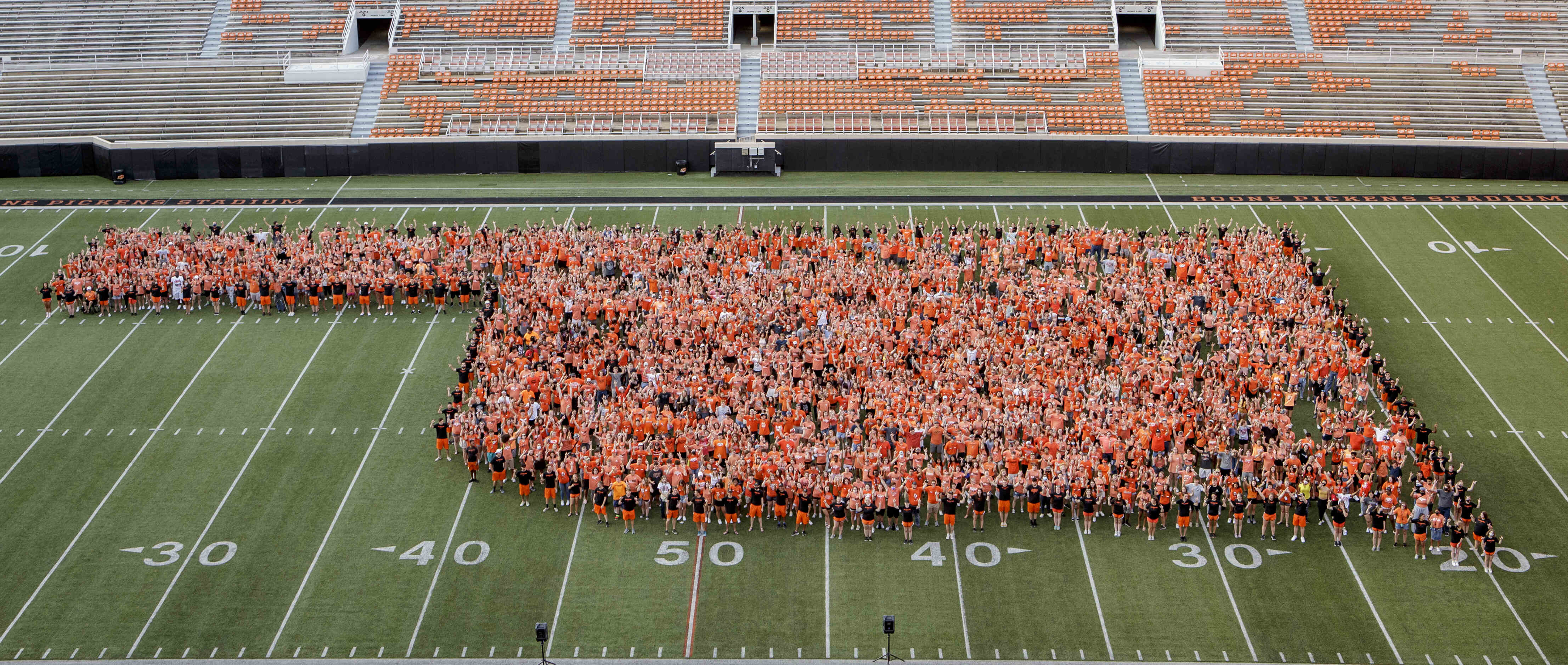 Image showing people standing together in an Oklahoma shape at Boone Pickens Stadium